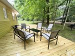 Spacious deck overlooking the backyard has great outdoor furniture